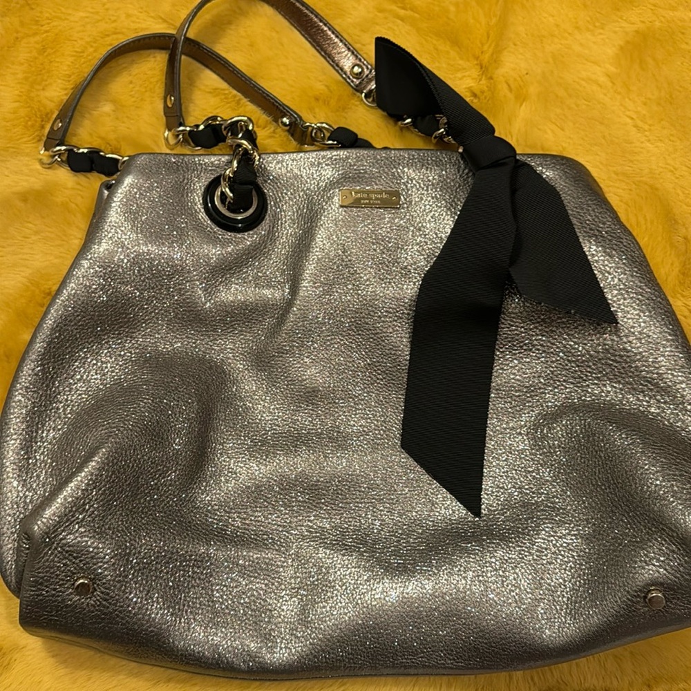 Kate Spade gray/gold shoulder bag with black bow.